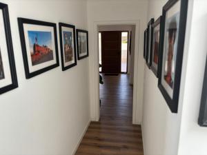 a hallway with a bunch of framed pictures on a wall at Villa Alvoria in Alvor