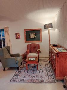 a living room with a chair and a table at Good Vibes in Uniondale