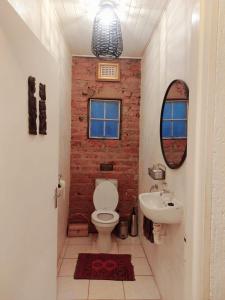 a bathroom with a white toilet and a sink at Good Vibes in Uniondale +6 photos