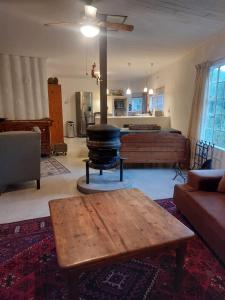 a living room with a wood stove in the middle at Good Vibes in Uniondale