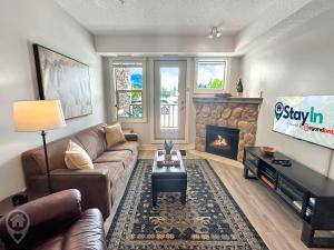 a living room with a couch and a fireplace at Silver Rock by StayIn in Fernie