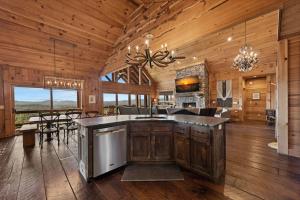 a kitchen and living room with a dining room and a dining table at Sky's the Limit in Mineral Bluff