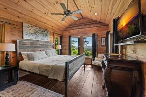 a bedroom with a bed and a ceiling fan at Sky's the Limit in Mineral Bluff