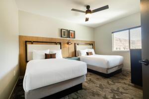 a bedroom with two beds and a ceiling fan at EBAC Moab in Moab +28 photos
