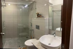 a bathroom with a sink and a glass shower at Iconic Galaxy in Rajagiriya