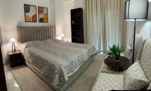 a bedroom with a bed and a table and chairs at Iconic Galaxy in Rajagiriya
