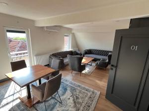 a living room with a table and chairs and a couch at Panorama Residence Apartments in Kumanovo