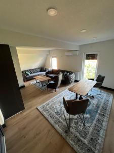 a living room with a couch and a table and chairs at Panorama Residence Apartments in Kumanovo