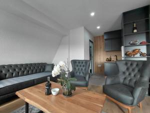 a living room with a couch and chairs and a table at Panorama Residence Apartments in Kumanovo +21 photos