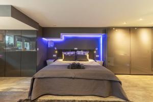a bedroom with a large bed with a blue light at The Orange Canals Suite in Amsterdam