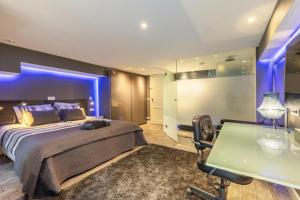 a bedroom with a bed and a table and a desk at The Orange Canals Suite in Amsterdam