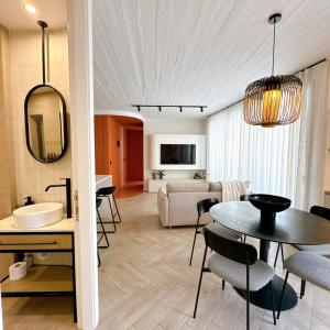 a living room and dining room with a table and chairs at Stylish Designer Apartment in Mellieħa