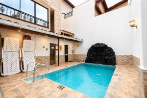 a swimming pool in the middle of a building at Hotel Colores Boutique in Medellín