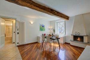 a living room with a table and a fireplace at Palazzo Gritti in Morcote