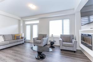 a living room with two couches and a fireplace at Home in Waterdown in Hamilton