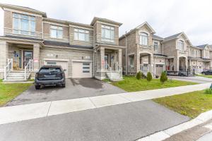 a car parked in front of a large house at Home in Waterdown in Hamilton