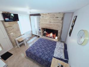 a bedroom with a bed and a fireplace at Cosy Appartement Hyper Centre-Ville in Quimper