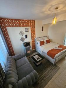 a hotel room with a bed and a couch at Pinnacle Homes 254 - Kamakis in Ruiru