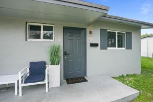 a house with a blue door and a blue chair at 11432 Lincoln Blvd in Richmond Heights