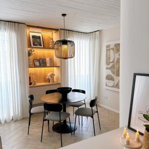 a dining room with a table and chairs at Stylish Designer Apartment in Mellieħa