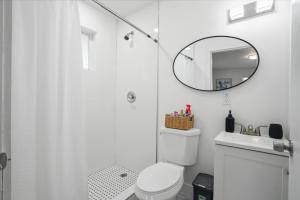 a white bathroom with a toilet and a mirror at 11432 Lincoln Blvd in Richmond Heights +8 photos