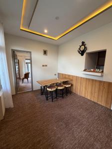 a dining room with a table and a television at Mariner Lodge Skardu in Skardu