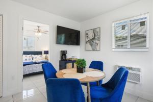 a dining room with a table and blue chairs at 11432 Lincoln Blvd in Richmond Heights