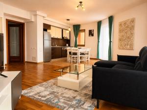 a living room with a couch and a table at Monte Carlo Palace Suites in Bucharest