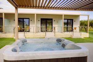 a hot tub in the backyard of a house at Aura Otto Luxury Living in Alexandroupoli