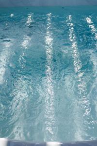 a pool of blue water with bubbles in it at Aura Otto Luxury Living in Alexandroupoli