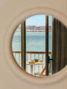 a view of the ocean seen through a mirror at Hôtel Les Brises in La Rochelle