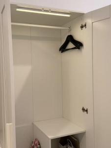 a walk in closet with a glass wall at Calm & Comfy at Sky House BSD in Cilenggang