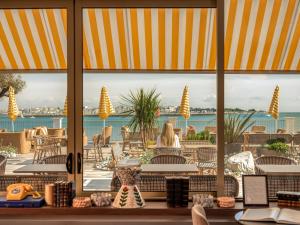 a view from the lobby of a resort with a view of the ocean at Hôtel Les Brises in La Rochelle