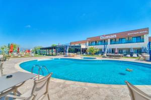 a swimming pool in front of a hotel at Duman Boutique Hotel in Mamaia