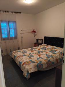 a bedroom with a bed with a quilt on it at Nice postion, belle vue in Pučišća