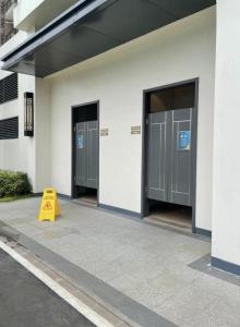 a yellow cone sitting in front of a building at Calm & Comfy at Sky House BSD in Cilenggang +3 photos