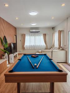 a pool table in the middle of a living room at The paperwhite poolvilla khaoyai in Ban Tha Chang