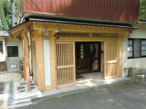 a building with a japanese style building at Onsen Minshuku Sakaeya in Shizukuishi