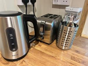 a kitchen counter with a coffee maker and a toaster at Half Moon Shepherds Huts in Plumpton