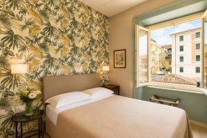 a bedroom with a bed and a window at Hotel della Vittoria in Ancona