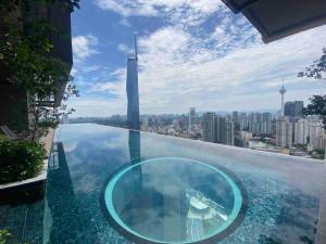 a glass infinity pool with a view of the shanghai tower at Luxury Suites By Lucentia Residence BBCC Kuala Lumpur in Kuala Lumpur