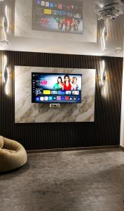 a flat screen tv hanging on a wall at Panorama Gora in Kutaisi