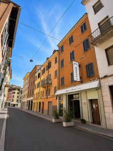 an empty street in a city with buildings at Hotel Brenta in Parma