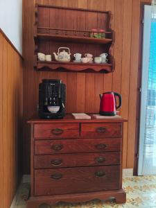 a wooden dresser with a coffee maker on top of it at Nice postion, belle vue in Pučišća