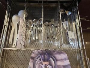 a metal shelf with utensils in a drawer at The Cozy Theory in Kharar