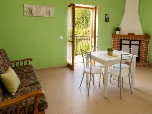 a living room with a table and chairs and a couch at Casa vacanze "Ellen" - AAUT in Bianchi +19 photos