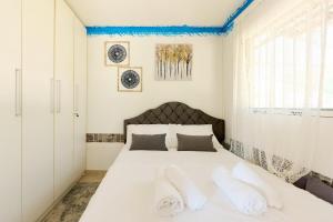 a bedroom with a white bed with two pillows at pRETTy Home with Private Pool, Sea View in Nea Kallikrateia +81 photos