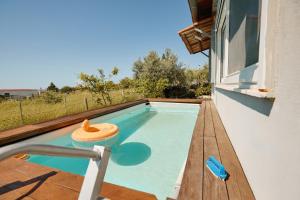 a small swimming pool on a balcony of a house at pRETTy Home with Private Pool, Sea View in Nea Kallikrateia