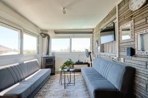 a living room with couches and a brick wall at pRETTy Home with Private Pool, Sea View in Nea Kallikrateia