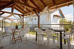 a patio with a table and chairs on a patio at pRETTy Home with Private Pool, Sea View in Nea Kallikrateia